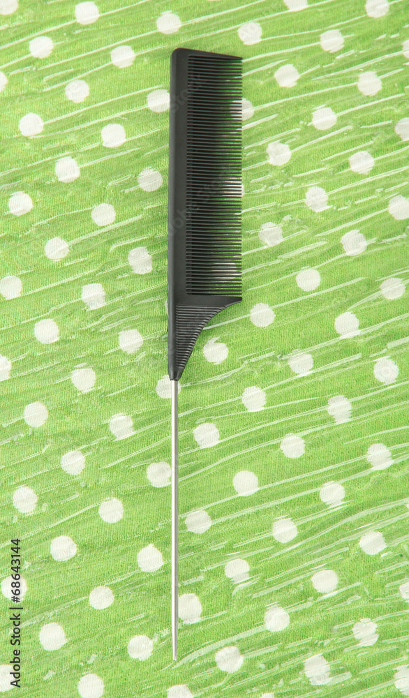 Black comb on color background