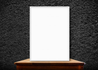 Wall Mural - blank photo frame on wood table at black stone wall,perspective