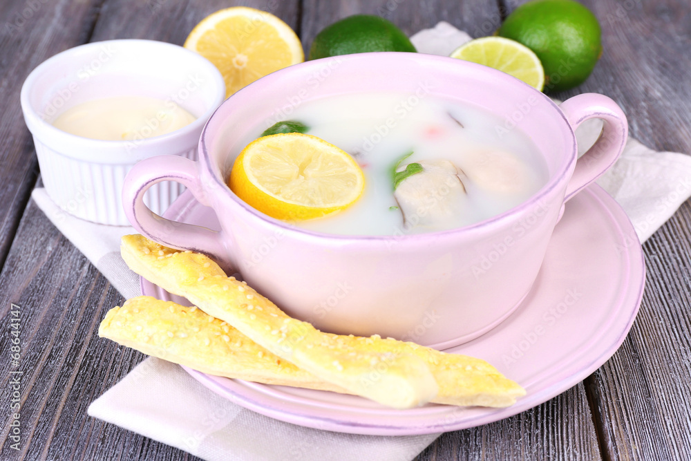 Tasty soup with oysters on wooden table