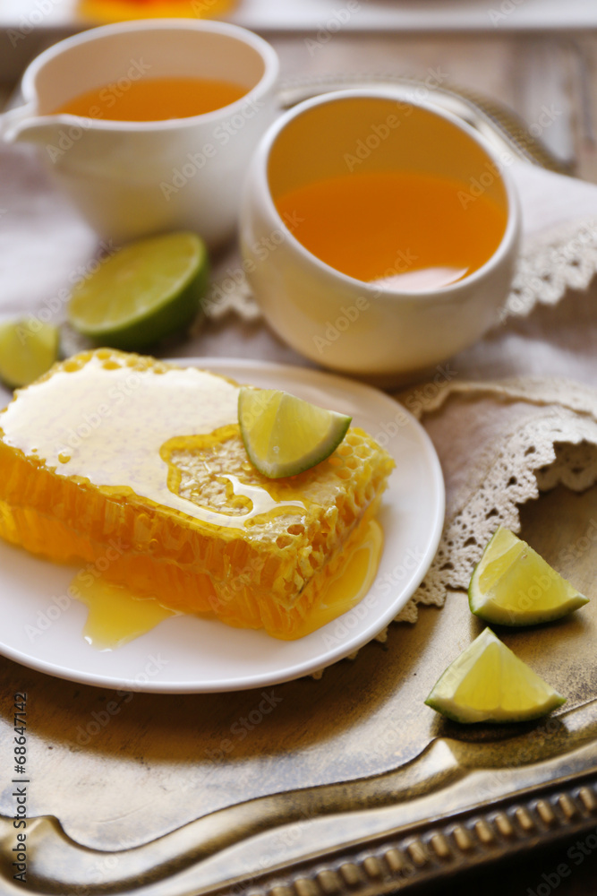 Fresh honey snack on tray on wooden table