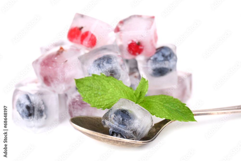 Ice cubes with forest berries, isolated on white