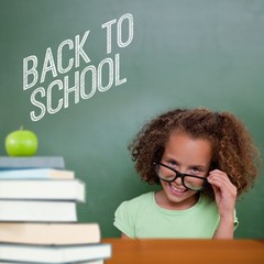 Poster - Composite image of cute pupil tilting glasses