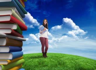 Poster - Composite image of smiling student holding textbook
