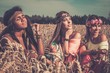 Multi-ethnic hippie girls  in a wheat field