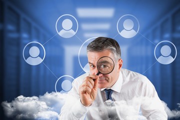 Poster - Composite image of focused businessman with magnifying glasses