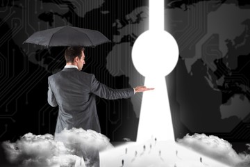 Poster - Composite image of businessman holding an umbrella with hand out
