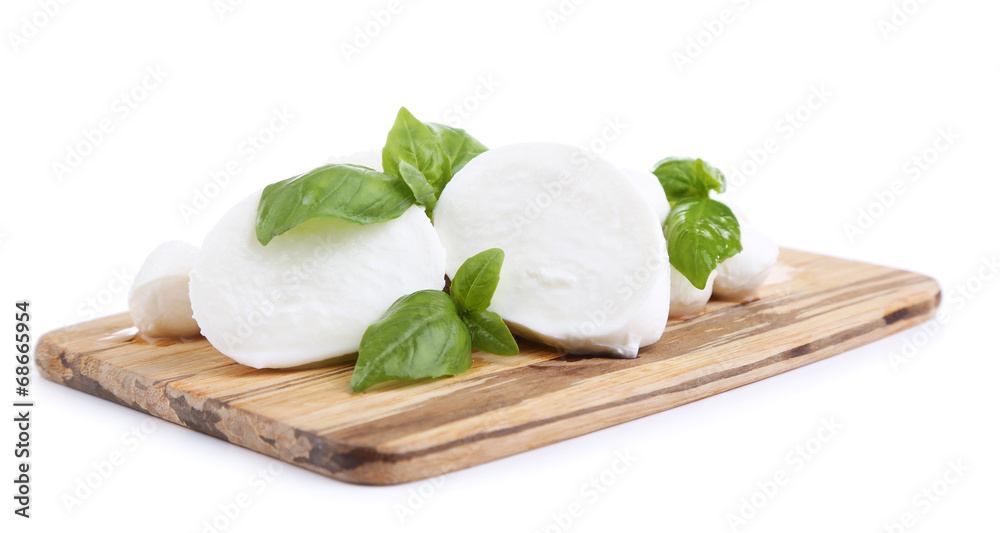 Tasty mozzarella with basil on wooden board isolated on white