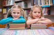 © WavebreakmediaMicro - Cute pupils smiling at camera in library