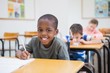 © WavebreakmediaMicro - Disabled pupil writing at desk in classroom
