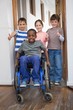 © WavebreakmediaMicro - Disabled pupil with his friends in classroom