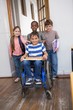 © WavebreakmediaMicro - Disabled pupil with his friends in classroom
