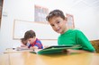 © WavebreakmediaMicro - Cute pupils reading at desks