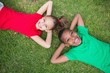 © WavebreakmediaMicro - Cute children smiling at camera outside on the grass