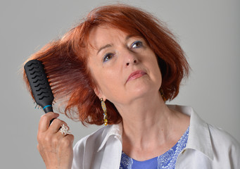 Beautiful woman drying her red hair