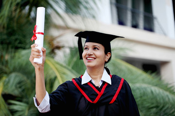 Wall Mural - Young female student with diploma at outdoors