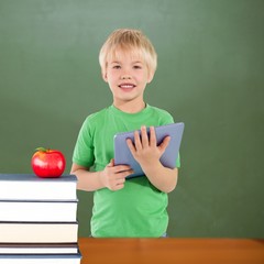 Poster - Composite image of cute boy using tablet