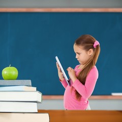 Poster - Composite image of cute girl using tablet