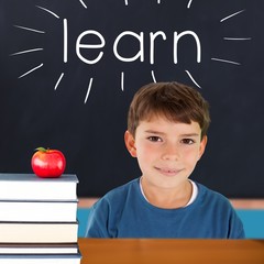 Poster - Learn against red apple on pile of books in classroom
