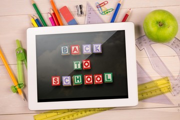 Poster - Composite image of digital tablet on students desk