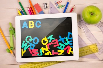 Poster - Composite image of digital tablet on students desk