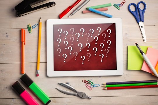 Composite image of digital tablet on students desk