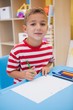 © WavebreakMediaMicro - Cute little boy drawing at desk