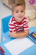 © WavebreakMediaMicro - Cute little boy sitting at desk