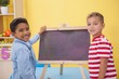 © WavebreakMediaMicro - Cute little boys drawing on chalkboard