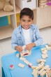 © WavebreakMediaMicro - Cute little boy playing with building blocks