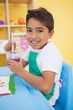 © WavebreakMediaMicro - Cute little boy painting at table in classroom
