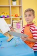 © WavebreakMediaMicro - Cute little boy painting at table in classroom