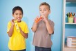 © WavebreakMediaMicro - Cute little boys playing musical instruments in classroom