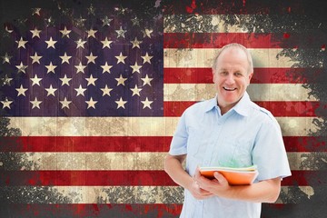 Composite image of mature student holding notebooks