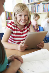 Wall Mural - Elementary School Pupil Using Digital Tablet In Classroom