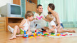 © JackF - Family of four at home with toys