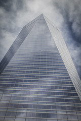 futuristic, skyscraper with glass facade and clouds reflected in