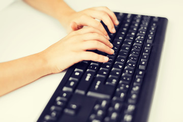 Wall Mural - student girls hands typing on keyboard