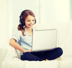 Poster - girl with laptop computer and headphones at home