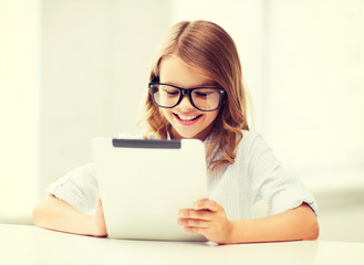 Wall Mural - smiling girl in glasses with tablet pc at school