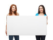 © Syda Productions - two smiling young girls with blank white board