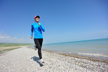 Poster - Runner athlete running on stone beach of qinghai lake