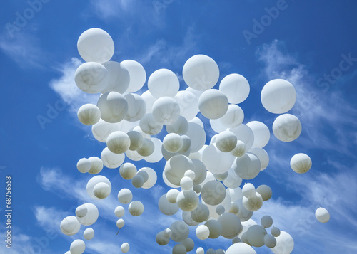 Fototapeta na wymiar White balloons on the blue sky