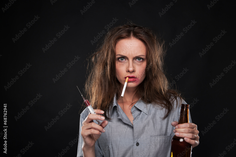 cigarette dangling portrait of woman smoking cigarette hanging out of her mouth. Stock Photo