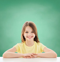 Canvas Print - beautiful little girl sitting at table