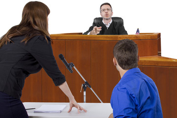 defendant with lawyer speaking to a judge in the courtroom