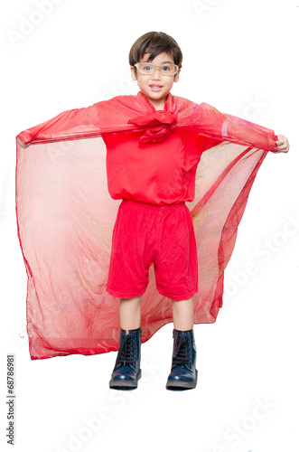 Fotografering little boy is dressed up as a superhero flying