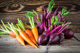 Fototapeta Kuchnia - Fresh vegetables carrots, beetroots on  wooden background