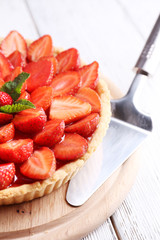 Sticker - Strawberry tart on wooden tray, on color wooden background