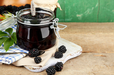 Wall Mural - Tasty blackberry jam and fresh berries, on wooden table