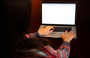 Back view portrait of a woman using laptop